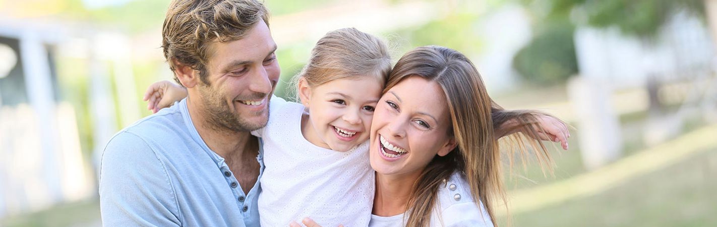 Young couple having fun with their daughter