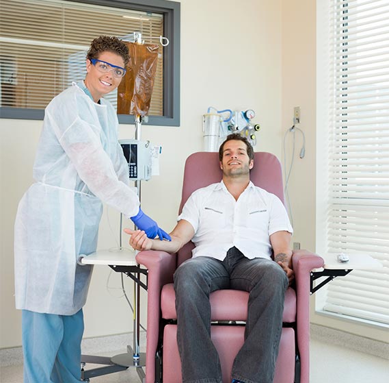Infusion therapist preparing a treatment for a patient